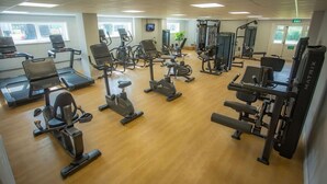 A gym with various exercise equipment, including treadmills, stationary bikes, and weight machines. - Bells Hotel (Coleford)