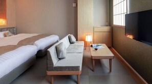 A hotel room with a bed, a sofa, a small table, a lamp, and a TV. - Modern Japanese Superior Twin Room for 2 people  / Kyoto City Kyōto (Kyoto City)