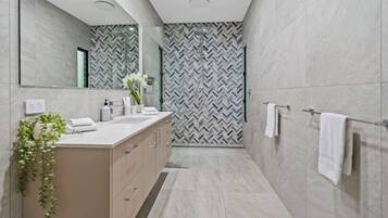 Shower, hair dryer, towels, shampoo