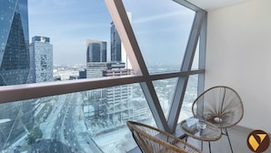 A high-rise room with a large window offering a cityscape view. - Vogue Park Tower DIFC  (Dubai)