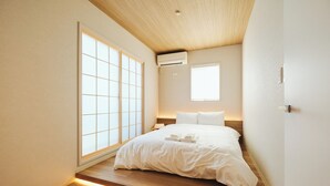 A minimalist bedroom with a large sliding shoji screen door, a single bed with white linens, and a small window providing natural light. - 2026/1/6 New open! Lux Villa(112 ㎡) 6 min Shinjuku/10 min Shibuya (Wakaba, Shinjuku-ku)