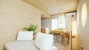 A modern living room with a sofa, a dining table, and chairs. - 2026/1/6 New open! Lux Villa(112 ㎡) 6 min Shinjuku/10 min Shibuya (Wakaba, Shinjuku-ku)