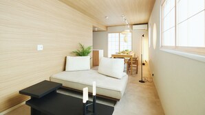 A modern living room with a sofa, a small table, and a dining area in the background. - 2026/1/6 New open! Lux Villa(112 ㎡) 6 min Shinjuku/10 min Shibuya (Wakaba, Shinjuku-ku)