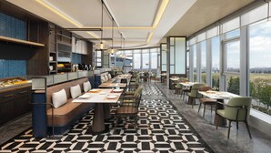A modern restaurant with a long counter, seating area, and large windows offering a city view. - Four Points by Sheraton Hanzhong Riverside (Hanzhong)