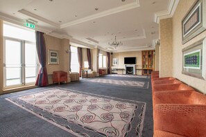 A hotel lobby with a fireplace, seating area, and a television. - Executive Double Room (Bournemouth)