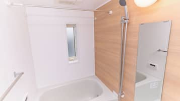 Combined shower/tub, free toiletries, hair dryer, slippers