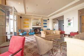 A spacious living room with a fireplace, comfortable seating, and a glass coffee table. - Standard family room for 4(2A+2C) (Bournemouth)
