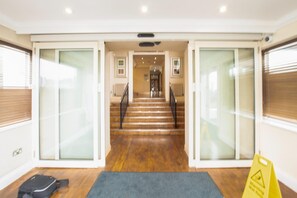 A hotel entrance with a staircase leading to a reception area. - Bournemouth East Cliff by Belvilla - Superior Feature w/ View (Bournemouth)