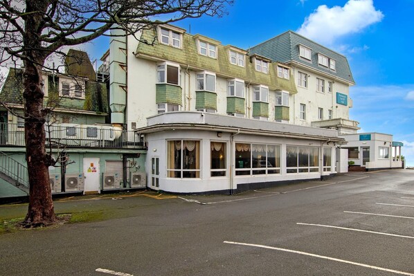 A building with multiple windows and a flat roof, adjacent to a tree. - Bournemouth East Cliff by Belvilla - Superior Feature w/ View (Bournemouth)