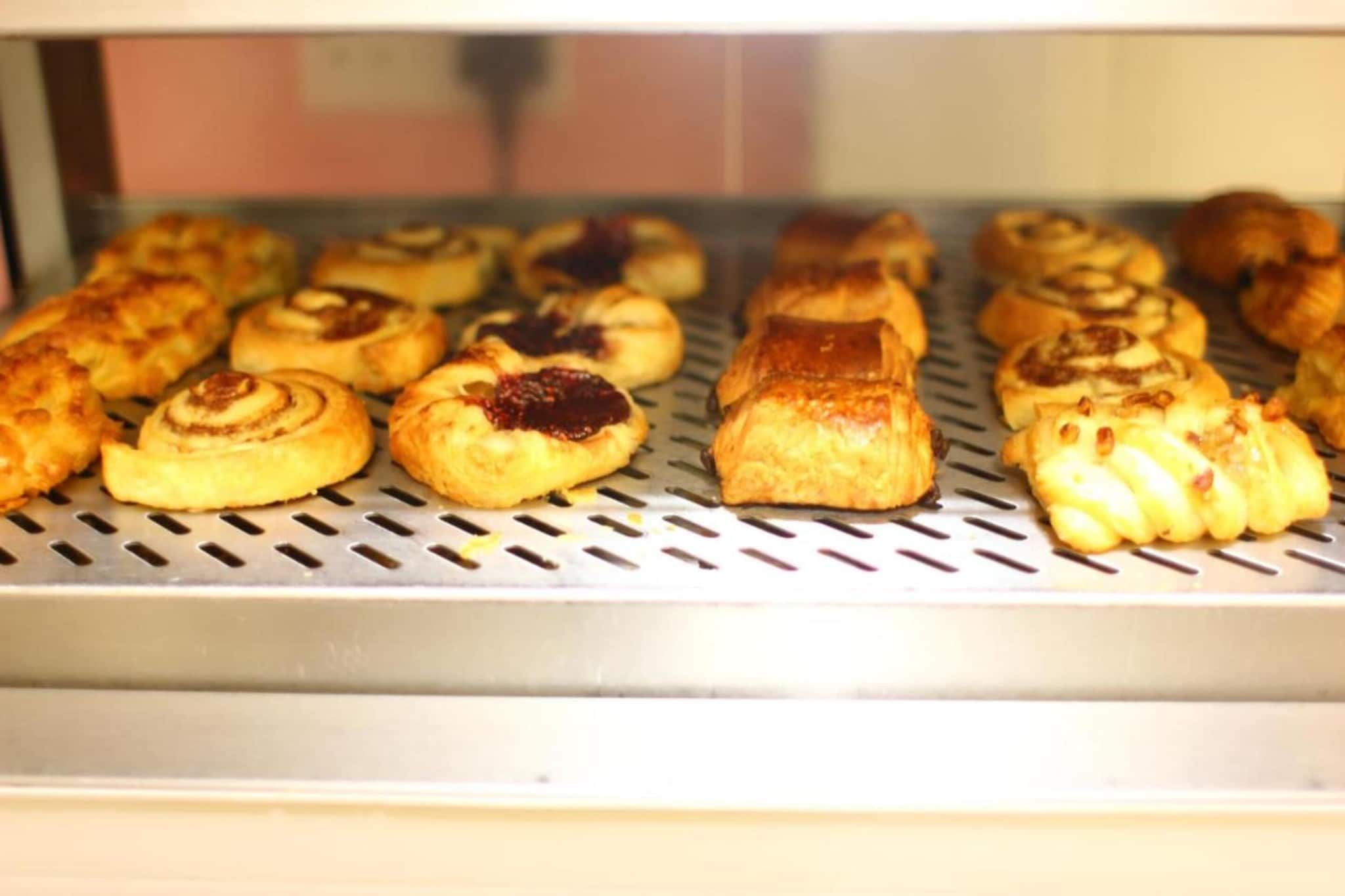 A bakery display case with various baked goods.