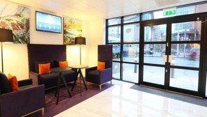 A lobby with seating, a digital display, and large windows. - Cardiff Bute Terrace Hotel - Standard Family of 3 Room (Cardiff)
