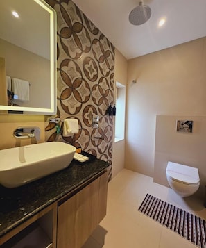 A bathroom with a large sink, mirror, and a shower area. - HERITAGE KASHINAAMA EK KAHANI BANARAS KI (Varanasi)