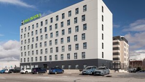 A multi-story hotel with a modern design, featuring a prominent sign at the top. - B&B HOTEL Madrid Vallecas La Gavia (Madrid)