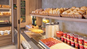 A buffet with various food items including bread, pastries, and deli meats. - B&B HOTEL Madrid Vallecas La Gavia (Madrid)