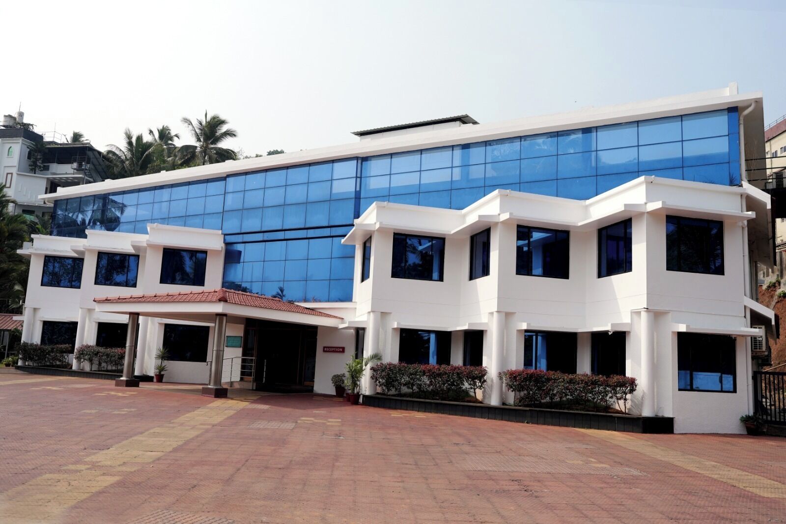 A modern building with a glass facade and a white exterior.