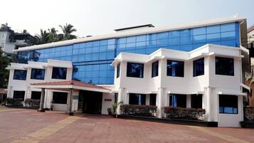 A modern building with a glass facade and a white exterior.