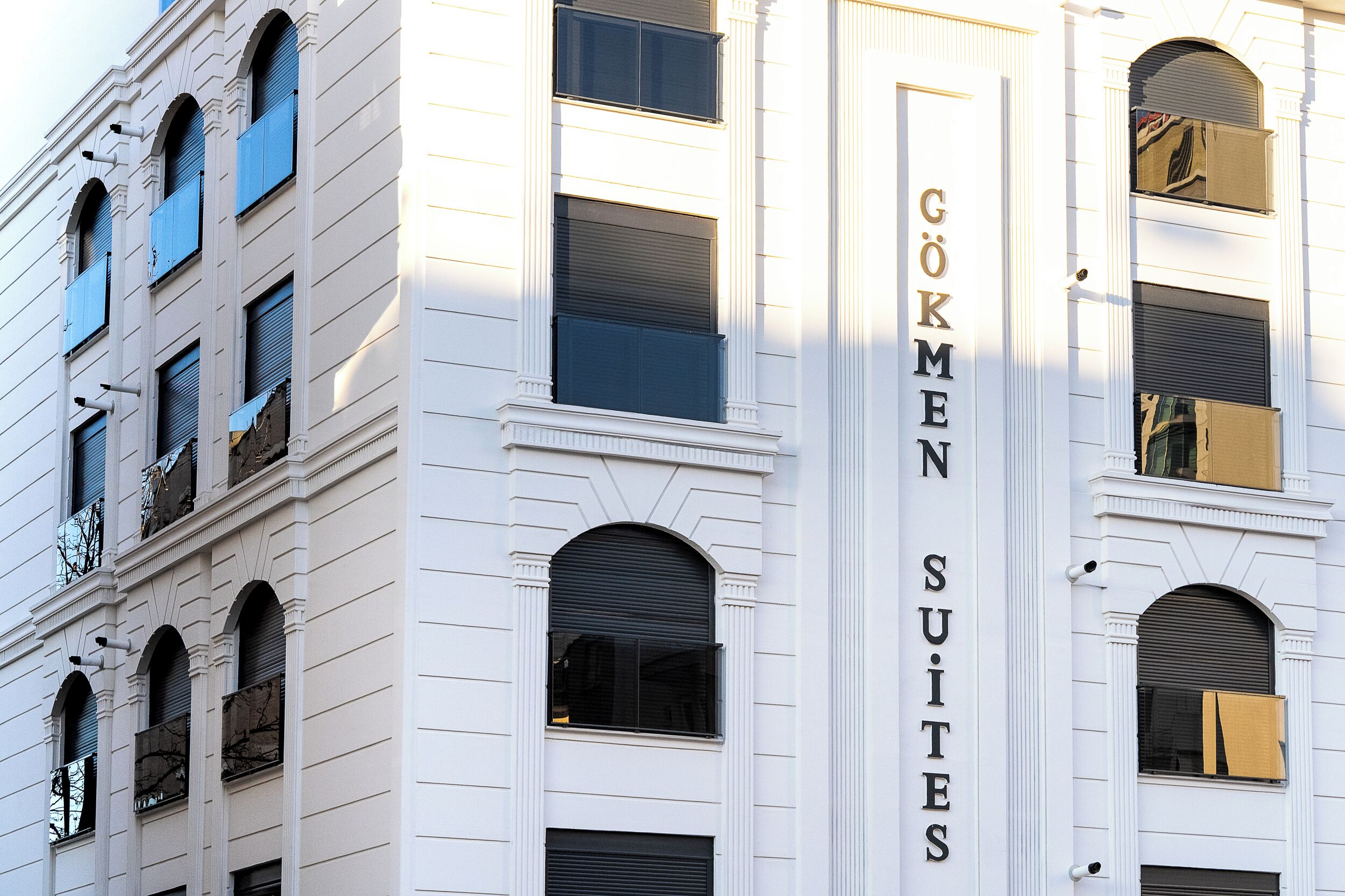 A building with the sign "GÖKMEN SUITES" indicating a hotel or accommodation.
