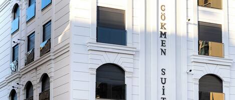 A building with the sign "GÖKMEN SUITES" indicating a hotel or accommodation.