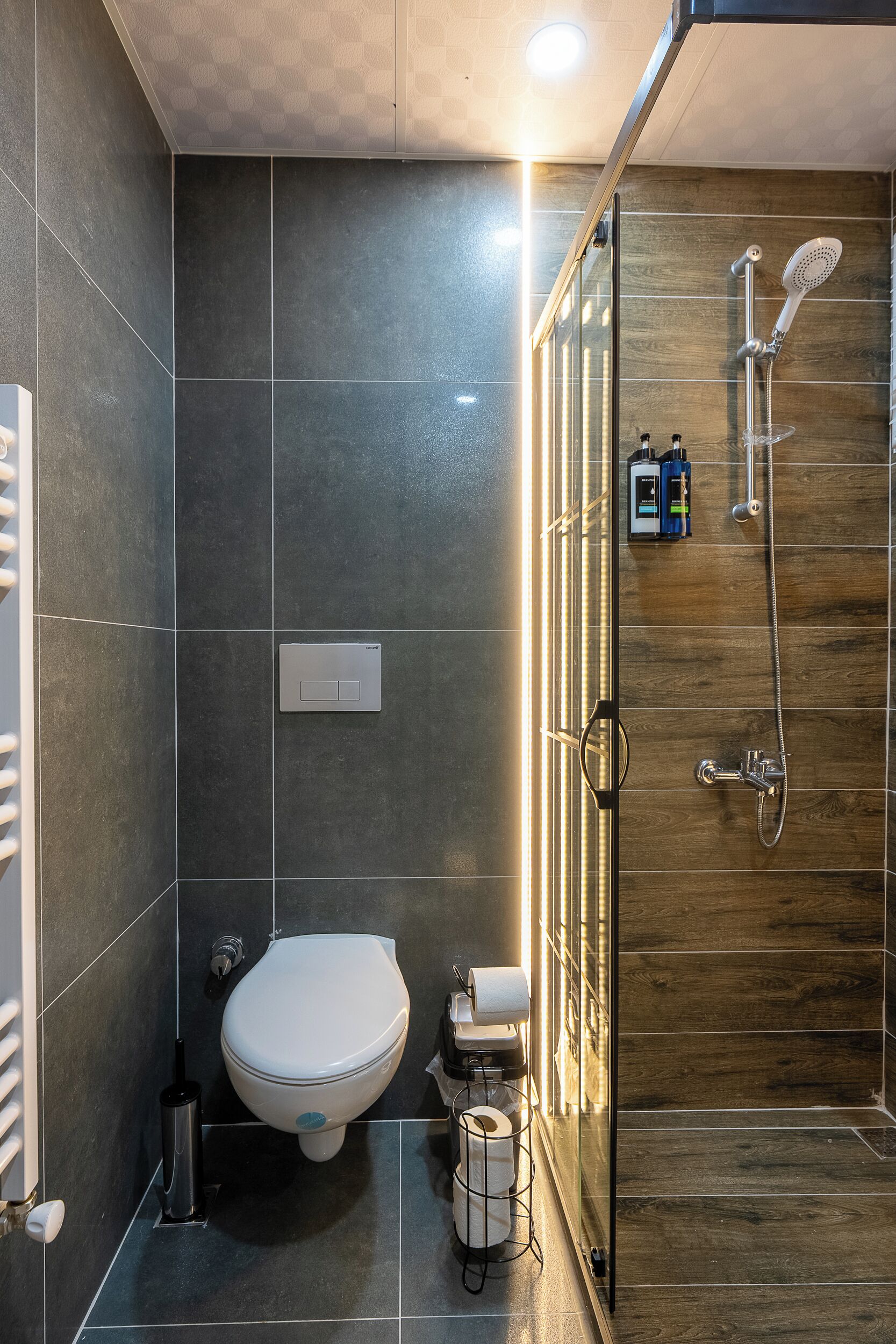 A modern bathroom with a toilet, bidet, and shower.