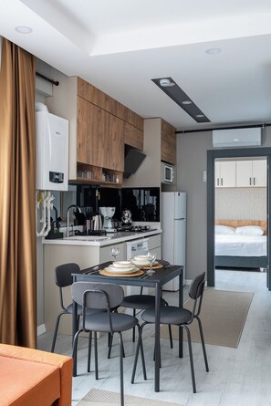 Deluxe Apartment, 1 Bedroom, Kitchen | Living area | 80-cm TV with cable channels, Netflix, streaming services - Gokmen Suites (Antalya)