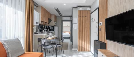 Deluxe Apartment, 1 Bedroom, Kitchen | Living area | 80-cm TV with cable channels, Netflix, streaming services
