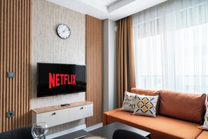 Deluxe Apartment, 1 Bedroom, Kitchen, Ground Floor | Living area | 80-cm TV with cable channels, Netflix, streaming services - Gokmen Suites (Antalya)
