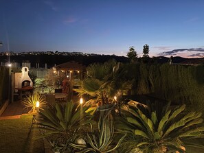 A patio area with a barbecue grill, seating, and potted plants. - Sun-Drenched Garden Apartment, Castillo Duquesa (Manilva)