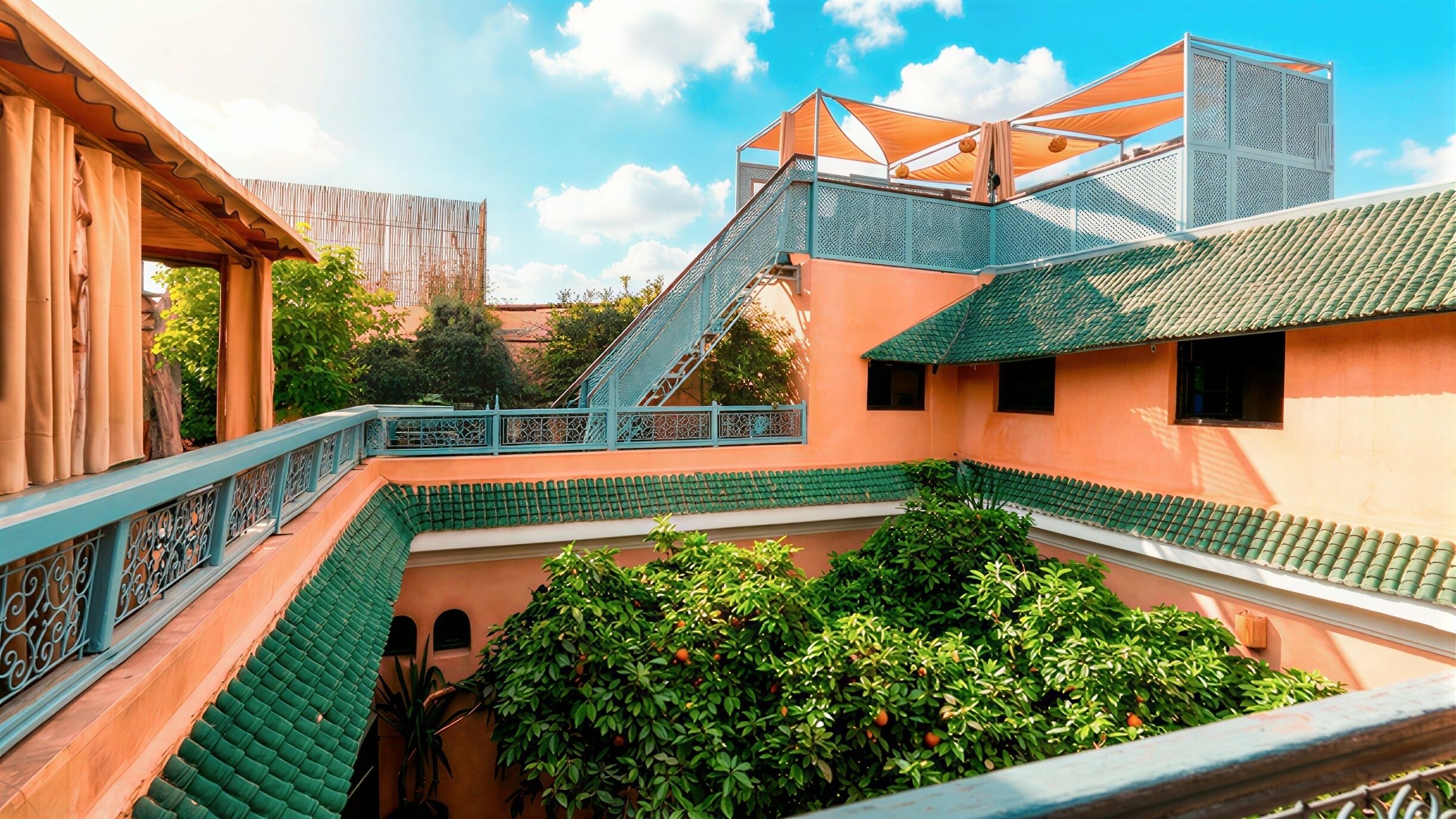 A courtyard with a staircase, a wooden structure, and green foliage.