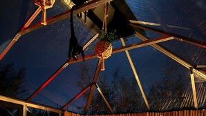 A tented accommodation with a bed, hanging decorations, and a bamboo wall. - Unique 'Wapa Lodge' Accommodation with Shared Garden (Gras)