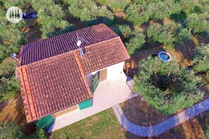 An aerial view of a house with a tiled roof, surrounded by greenery. - Tuscan idyll: Apartment near Montecarlo in an olive grove (Toscana)