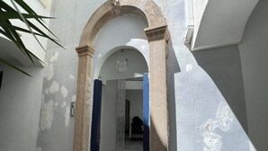 An arched doorway leading into a room with patterned tile flooring. - Stylish 1BR City Apartment with Stunning Rooftop Terrace (Gibraltar)