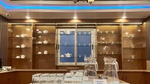A modern kitchen with a central island, glass shelves, and a chandelier. - WORMWOOD SYNERGY NEW MANDALA  (Darjeeling)