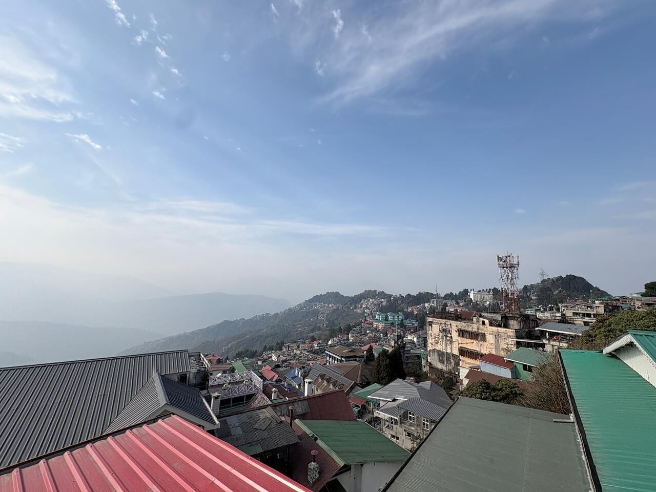 A town with buildings and a mountain in the background.