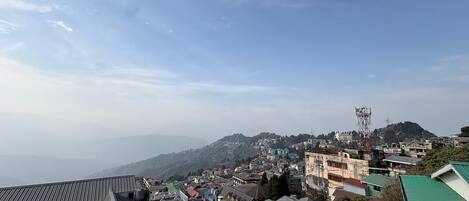 A town with buildings and a mountain in the background.