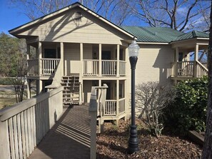 A two-story building with a porch, a staircase, and a lamp post. - Apple Valley  53 at Rumbling Bald (Lake Lure)
