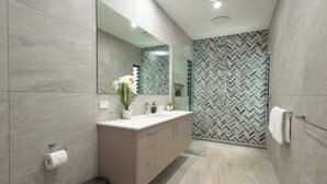 A modern bathroom with a large mirror, a vanity with a sink, and a shower area. - Barron Heights in Caravonica (Cairns)