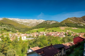 A mountainous landscape with a village and houses.