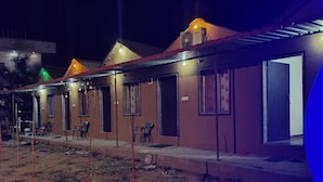 A row of single-story buildings with individual doors, some with small steps leading up to the entrance. - Fortune Heritage Resort  (Shri Madhopur)