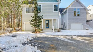 A two-story house with a front porch, a garage, and a driveway with snow. - 1 Mi to Bethany Beach: Family Home on Golf Course! (Bethany Beach)