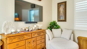 A living room with a wooden dresser, a television, a framed artwork, and a comfortable sofa. - Hike & Golf: Tucson Couple's Retreat w/ Mtn Views! (Saddlebrooke)