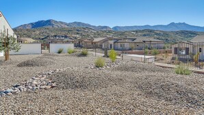 A residential area with houses, a gravel driveway, and mountains in the background. - Hike & Golf: Tucson Couple's Retreat w/ Mtn Views! (Saddlebrooke)