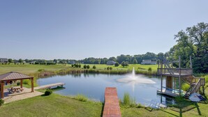 A tranquil lakeside setting with a wooden dock, a gazebo, and a small boat. - Family Home on 9 Acres! Climbing Wall & Gym (Thornville)