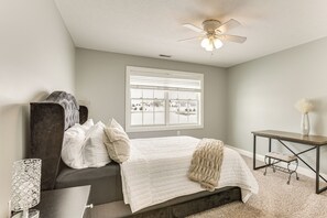 A bedroom with a bed, a desk, a chair, a window, and a ceiling fan. - Family Home on 9 Acres! Climbing Wall & Gym (Thornville)