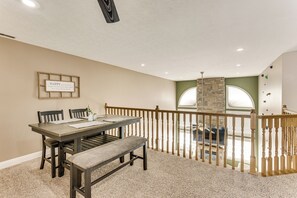 A conference room with a long table, chairs, and a bench. - Family Home on 9 Acres! Climbing Wall & Gym (Thornville)