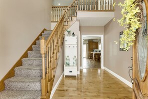 A staircase with wooden balusters and carpeted steps leading to a landing with a white cabinet. - Family Home on 9 Acres! Climbing Wall & Gym (Thornville)