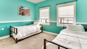A room with teal walls, two single beds, a window with blinds, and a painting on the wall. - Family Home on 9 Acres! Climbing Wall & Gym (Thornville)
