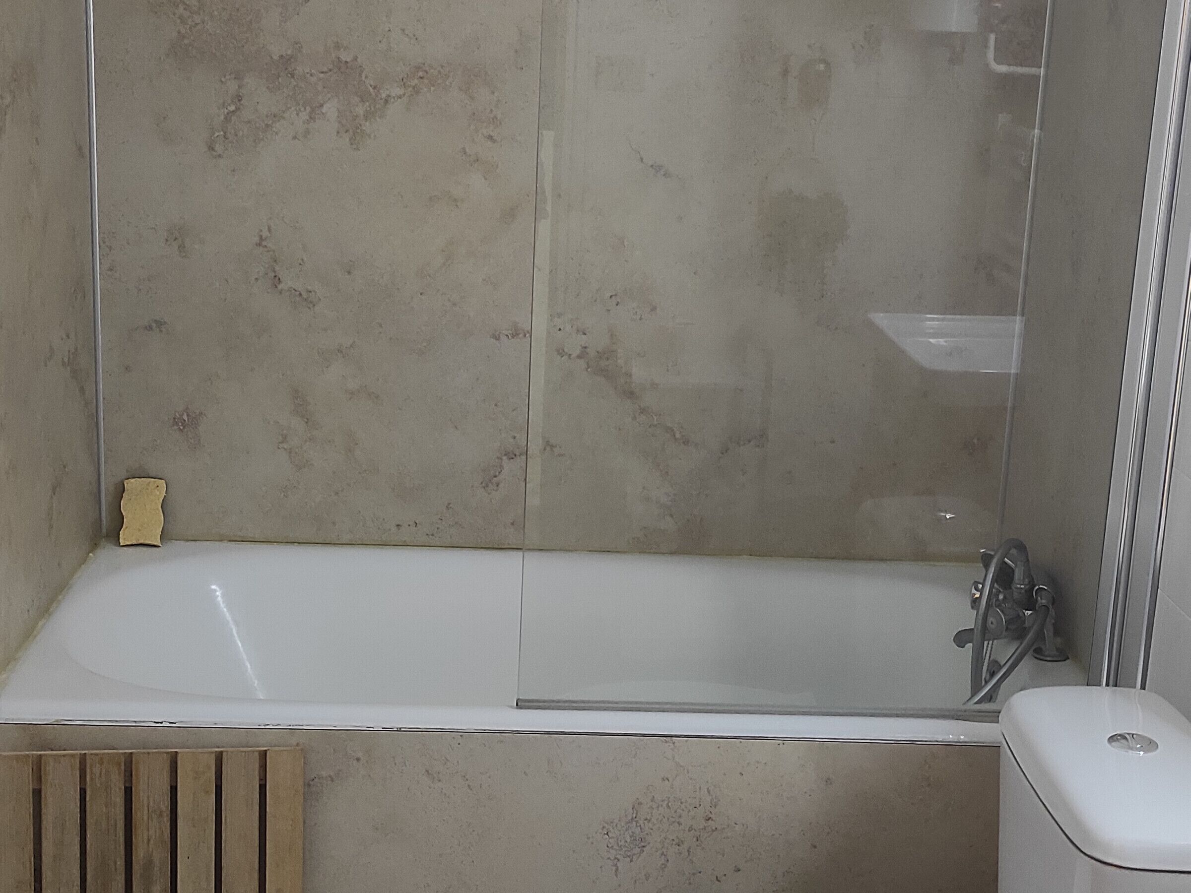 A bathroom with a bathtub, a shower, and a toilet.