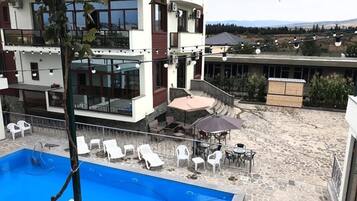 Seasonal outdoor pool, open 8:00 AM to 10:00 PM, pool umbrellas