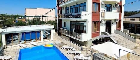 Seasonal outdoor pool, pool umbrellas, pool loungers