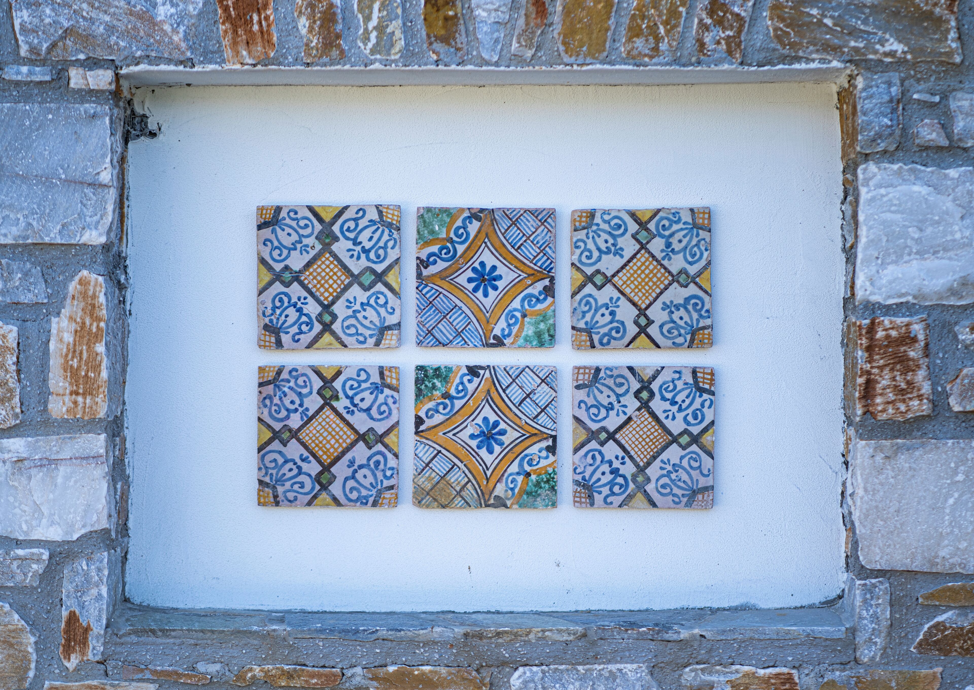 A wall with a six-paneled tile design.